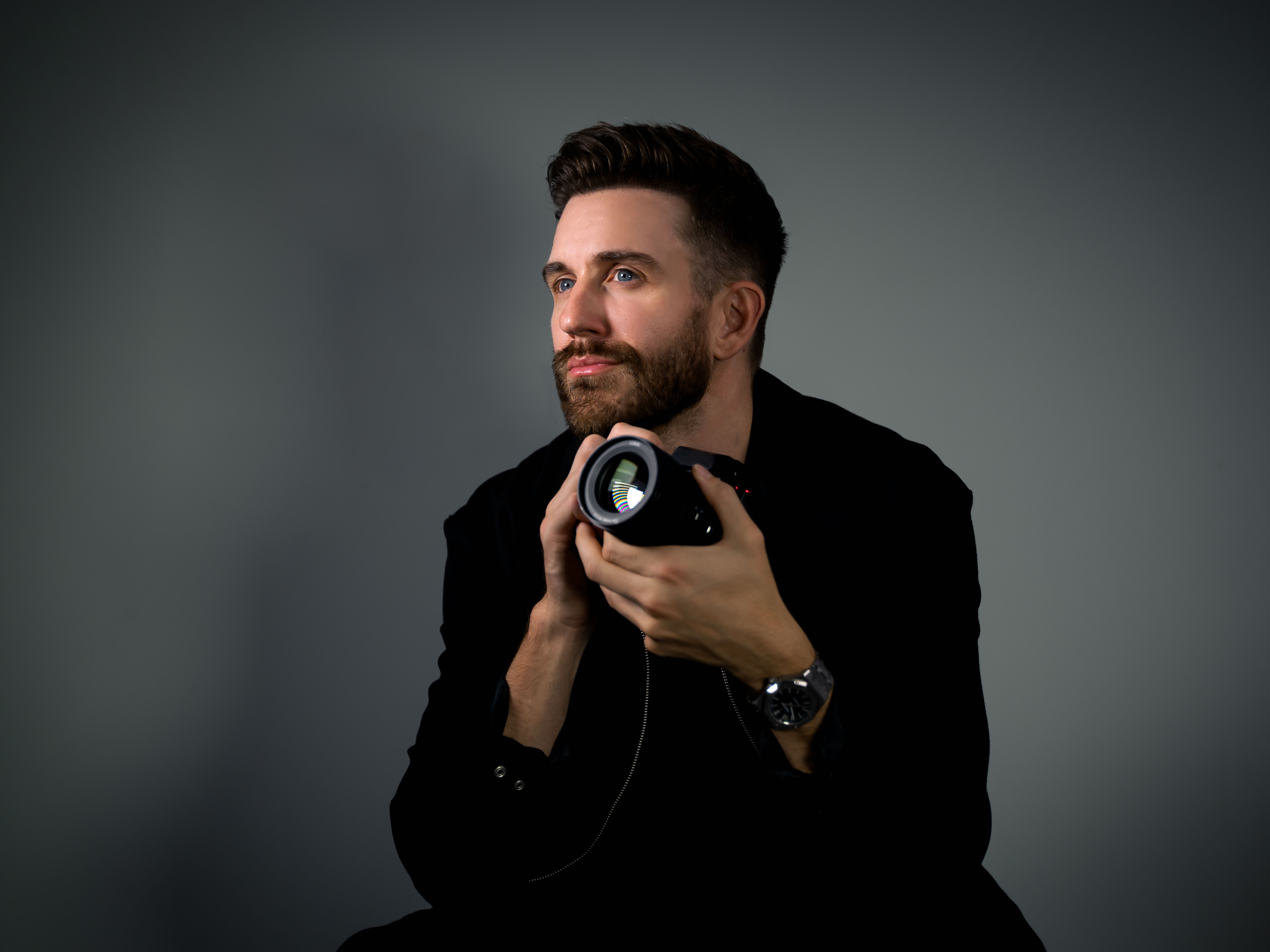Videographer holding a camera, side profile
