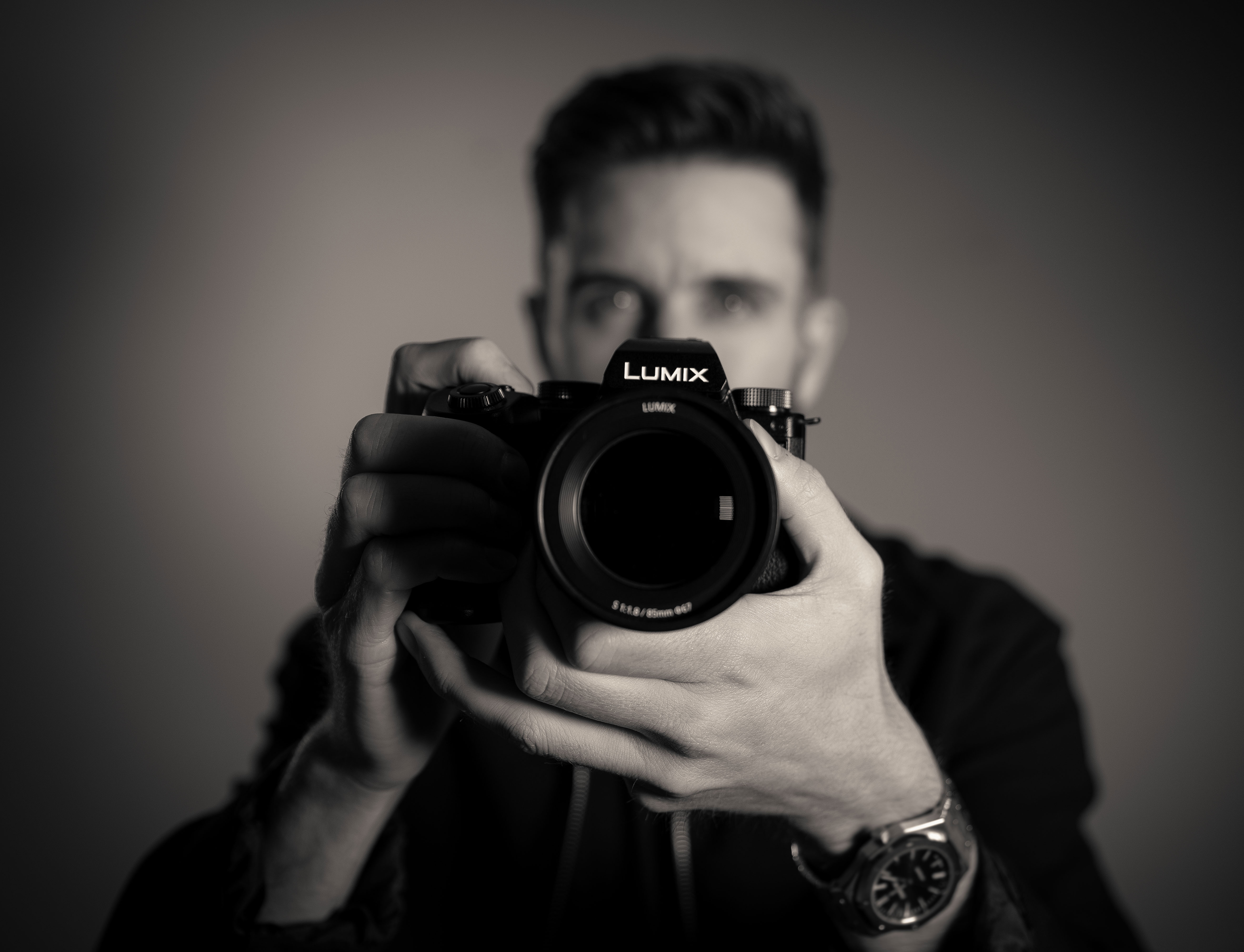 Videographer holding a Lumix camera